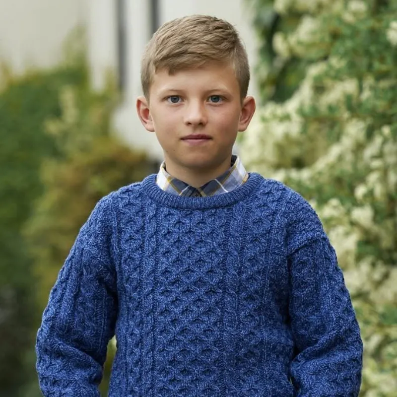 Child wearing a cream Aran sweater